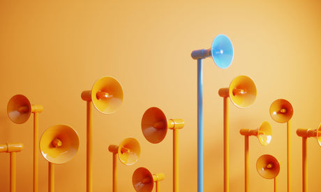 Orange microphones on sticks with one blue microphone above all else